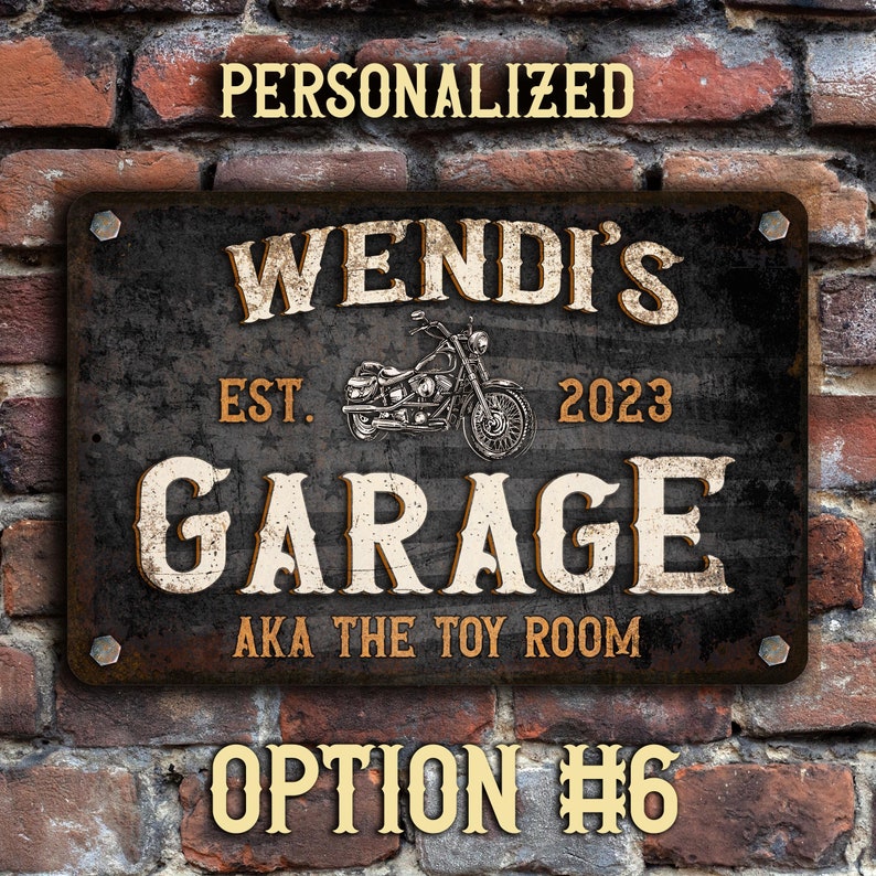 May include: A black and brown metal sign with the text "Wendi's Garage Est. 2023 AKA The Toy Room" and a motorcycle graphic. The sign has a distressed look and is personalized with a name and year.