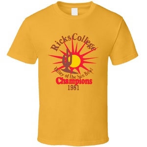 May include: Yellow t-shirt with a red and brown graphic of a cactus and sun with the text "Ricks College Valley of the Sun Bowl Champions 1981"