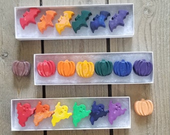 May include: A set of 10 Halloween-themed crayons in a rainbow of colors. The crayons are shaped like bats, pumpkins, and ghosts.