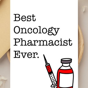 May include: A white card with black text that reads "Best Oncology Pharmacist Ever."  A black and red illustration of a syringe and a vial of medicine is below the text.