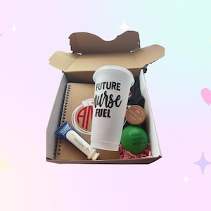 May include: An open cardboard box filled with items, including a white cup with "FUTURE Nurse FUEL" text, a notebook, a tube of lotion, a stress ball, and a small round container. The box is on a pastel background.
