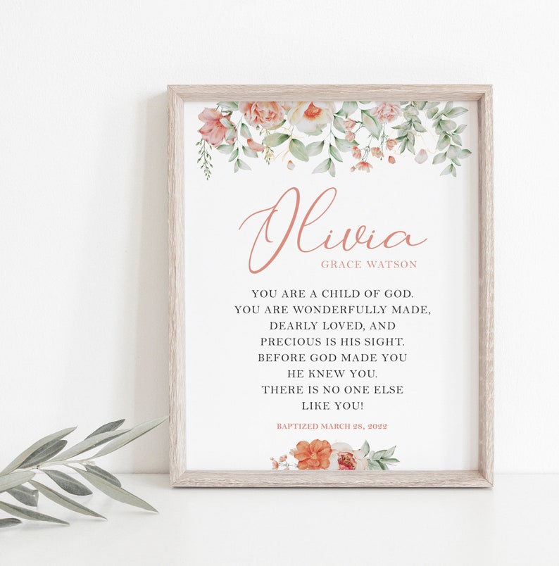 Puede incluir: Una impresi&oacute;n enmarcada con el nombre Olivia Grace Watson en texto rosa, rodeado de ilustraciones florales en acuarela. El texto dice: You are a child of God. You are wonderfully made, dearly loved, and precious in His sight. Before God made you He knew you. There is no one else like you! Baptized March 28, 2022.