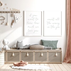 May include: Two white framed prints with grey text on a white background. The left print says "If you want to know how much we love you". The right print says "Count all the waves in the sea".