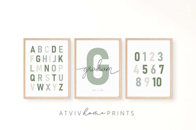 May include: Three framed prints with a green and beige color scheme. The first print features the alphabet in a grid pattern. The second print features the letter "G" in a large font with the name "graham" written in cursive below. The third print features the numbers 0-10 in a grid pattern.