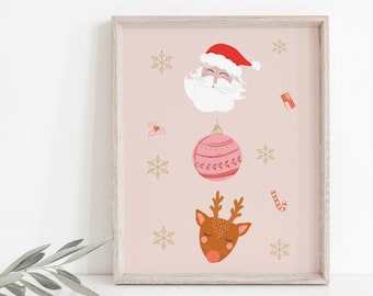 May include: A framed print featuring Christmas-themed illustrations. The artwork includes a Santa Claus face, a pink ornament, a reindeer head, snowflakes, and a candy cane on a light pink background. The frame is a light wood color.
