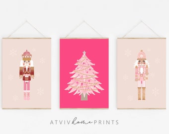 May include: Three framed art prints featuring holiday-themed illustrations. The prints include a pink Christmas tree on a fuchsia background, and two nutcracker figures in pink and brown tones, with snowflakes. The text "ATVIV home prints" is at the bottom.