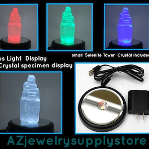 May include: A focus light display for crystal specimens. The image shows a small Selenite Tower crystal illuminated in red, green, and blue. The display base, USB cable, and power adapter are also visible. Text on the image reads: "Focus Light Display for Crystal specimen display" and "AZjewelrysupplystore."
