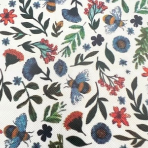 May include: White fabric with a repeating pattern of blue and red flowers, green leaves, and bumblebees.
