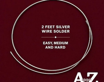 May include: A circular coil of silver wire solder with text that reads 2 FEET SILVER WIRE SOLDER EASY, MEDIUM AND HARD. The bottom right corner features a logo with the letters A and Z and the text Jewelry Supply & Crystal Shop.