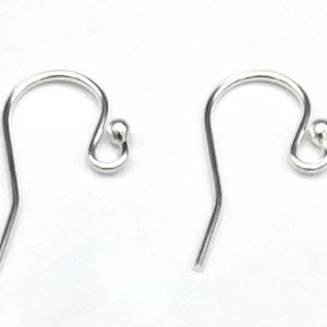 May include: Two silver earring hooks with a small ball at the end of each hook.