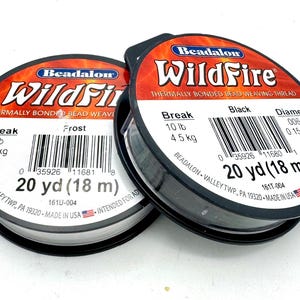 May include: Two spools of Beadalon WildFire thermally bonded bead weaving thread. One spool is black, the other is frost. Each spool contains 20 yards (18 m) of thread with a 10 lb (4.5 kg) break strength. The diameter is .006 in (0.15 mm).