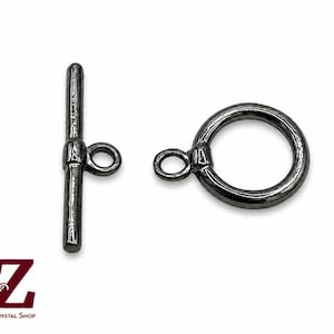 May include: A gunmetal-colored toggle clasp set consisting of a T-bar component and a circular ring component, each featuring a small loop for attachment. The logo A-Z Jewelry Supply & Crystal Shop is visible in the bottom left corner.