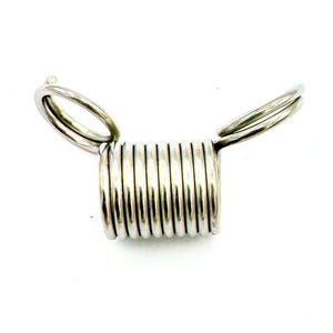 May include: Silver metal spring with two attached loops. The spring is coiled and has a shiny finish.