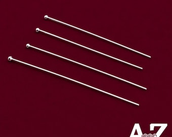 Puede incluir: Cuatro alfileres de cabeza de metal color plata, cada uno con un vástago recto y delgado y una pequeña bola redondeada en un extremo. Los alfileres están dispuestos en diagonal y en paralelo, con el texto AZ Jewelry & Crystal Shop en la esquina inferior derecha.
