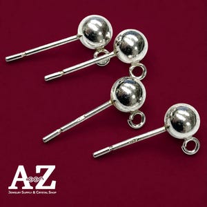 May include: Four silver-colored earring posts with a spherical ball top and a small circular loop at the base for attaching charms. The metal components have a reflective finish and include the text A-Z Jewelry Supply & Crystal Shop.