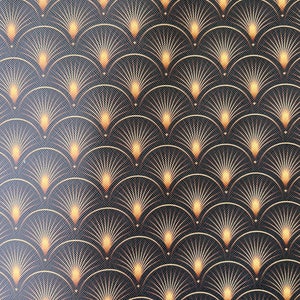 May include: A repeating pattern of gold and orange stylised sunbursts on a black background. The sunbursts are arranged in a repeating pattern of overlapping arcs.