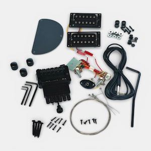 complete set of hardware in black with solderless electronic parts, showing pick ups, tremolo, toner and volume buttons, jack sockets and other parts to build your headless guitar by The Guitar Fabrik