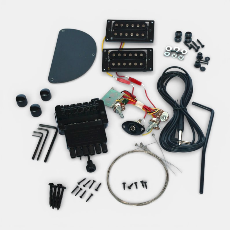 complete set of hardware in black with solderless electronic parts, showing pick ups, tremolo, toner and volume buttons, jack sockets and other parts to build your headless guitar by The Guitar Fabrik