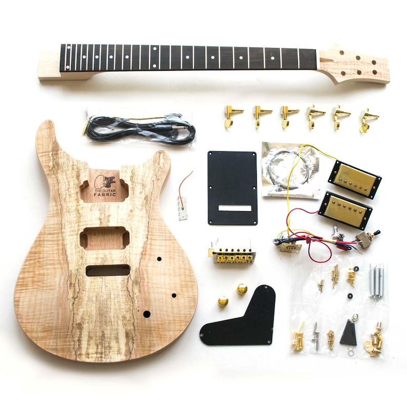 May include: A guitar kit with a natural wood body, black neck, and gold hardware. The kit includes all the parts needed to build a guitar, including pickups, tuners, a bridge, and a control plate. The kit also includes a set of strings, a cable, and a screwdriver.