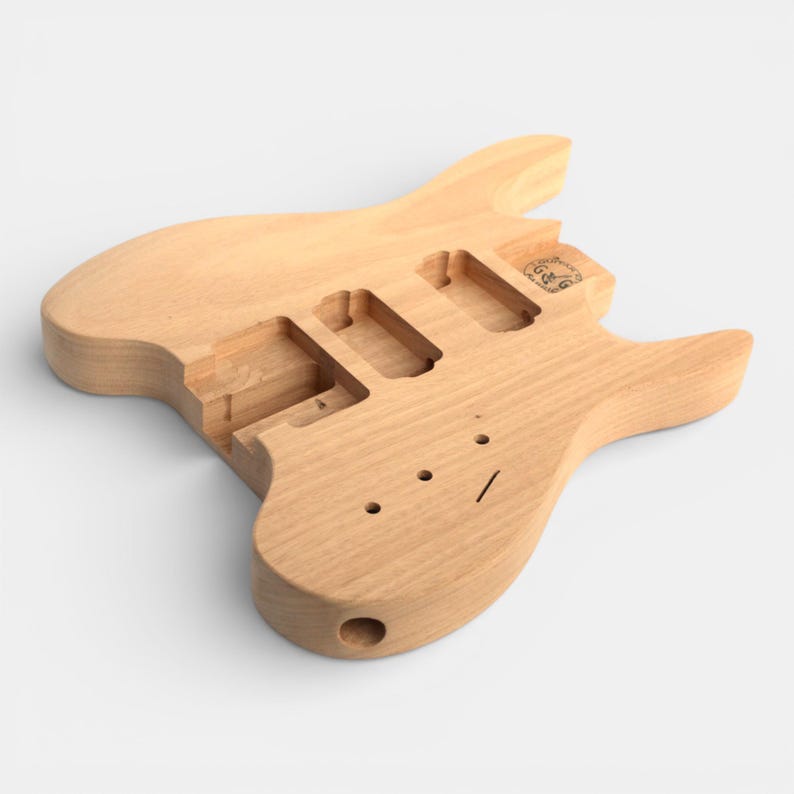 front side of guitar body for headless guitar kit with pick ups cravity and tremolo cravity pre-dilled, neck with fretboard and black nut installed by The Guitar Fabrik