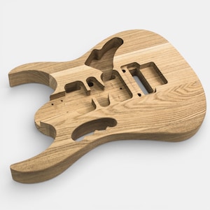 The body is made of ashwood and has a unique shape. cravity of pickups and shape are pre-made guitar body to build or replace Guitar Kit Jem by The Guitar Fabrik