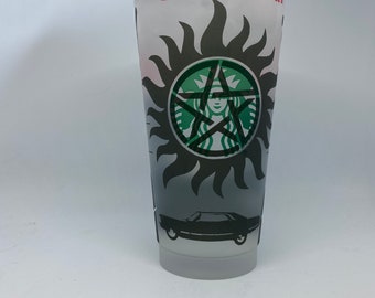 May include: A clear plastic cup with a black and green Supernatural logo, a black car, and the word "supernatural" in red lettering.