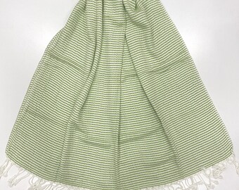 May include: A green and white striped cotton scarf with fringe on the edges.