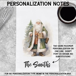 May include: A watercolor illustration of Santa Claus holding a gift box, standing in front of a green Christmas tree. The text "The Smiths" is written below the image. The text "TWO WORD MAXIMUM PERSONALIZATION ON ONE LINE. SCRIPT FONT AS SHOWN. NO SUBSTITUTIONS." is written on the right side of the image. The text "FOR NO PERSONALIZATION TYPE NONE IN THE PERSONALIZATION BOX." is written at the bottom of the image.