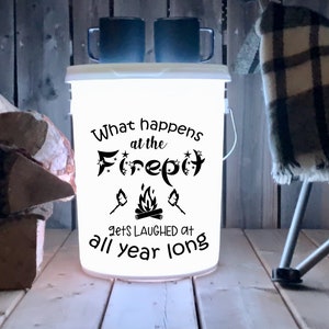 May include: White bucket with a black graphic that says "What happens at the Firepit gets laughed at all year long". The graphic includes a campfire, stars, and a moon.