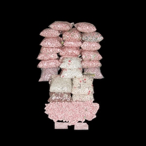 May include: A display of clear plastic bags filled with various candies, including pink, white, and green varieties. The bags are stacked in a vertical arrangement against a black background, suggesting a bulk candy sale or a confectionery shop.