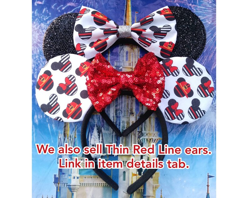 May include: A pair of black and white mouse ears with a red and white bow. The ears are decorated with a black and white pattern of fire hydrants and Mickey Mouse heads. The bow is made of red sequins. The ears are attached to a black headband. "We also sell Thin Red Line ears. Link in item details tab."