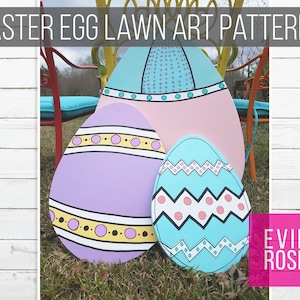May include: Three large wooden Easter eggs painted in different patterns. The largest egg is pink with a blue and white geometric design. The middle egg is purple with a yellow and black stripe design. The smallest egg is blue with a white and pink zigzag pattern. The eggs are sitting on green grass.
