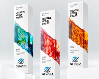 Puede incluir: Tres premios rectangulares blancos y altos con la inscripción City Design Merit Creative Vision Award 2026 Future Design Series y Nexora. Cada uno presenta una mancha abstracta tipo tinta en azul y verde, rojo, o naranja y amarillo.
