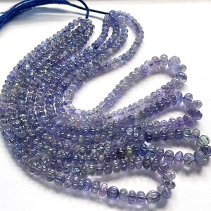 May include: A strand of light blue and purple gemstone beads. The beads are round and have a smooth, polished finish. The strand is approximately 18 inches long.