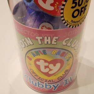 May include: A Beanie Babies Clubby IV plush toy inside a clear plastic container. The container has a colorful design with the words "JOIN THE CLUB" and "BEANIE BABIES OFFICIAL CLUB". A yellow sticker reads "50% OFF".