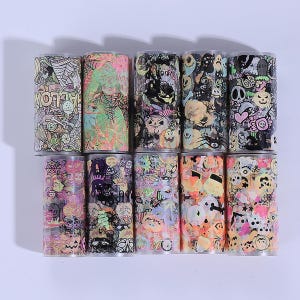 May include: A selection of Halloween-themed decorative tape rolls. The rolls display various spooky designs, including pumpkins, ghosts, spiderwebs, and the word "HALLOWEEN". The colour palette includes black, orange, green, and purple.