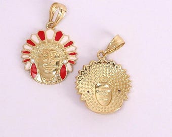 May include: Two gold-colored pendants featuring a Native American chief design. The pendants have a circular shape with a detailed face and headdress. The headdress is accented with red and white enamel. One pendant shows the front, the other the back.