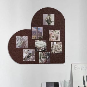 Könnte beinhalten: Ein Set aus drei Keramikbechern mit gesprenkelter, matter Oberfläche. Die Becher sind in Creme-, Hellgrau- und Dunkelgrautönen gehalten. Jeder Becher hat ein schlichtes, minimalistisches Design, ideal für Kaffee oder Tee.