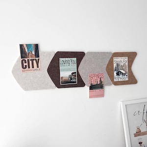 May include: A set of four chevron-shaped felt wall boards in light gray, dark brown, medium gray, and tan. The boards are arranged horizontally and feature pinned rectangular cards with text including CITY, Loving You, HAPPINESS OF LIFE, and Stands For My Heart.