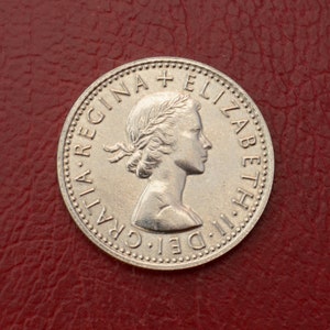 Obverse of a Queen Elizabeth II sixpence minted between 1953 and 1967. The diameter is 19.41 mm and it weighs 2.83g.