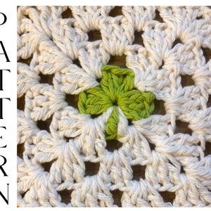 May include: Close-up of a crocheted doily with a green centre. The doily is made with white yarn and has a delicate, lacy pattern.