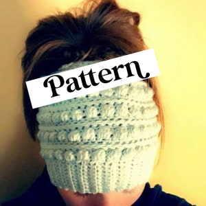 May include: A light blue crocheted headband with a textured pattern. The headband has a "Pattern" label on it.