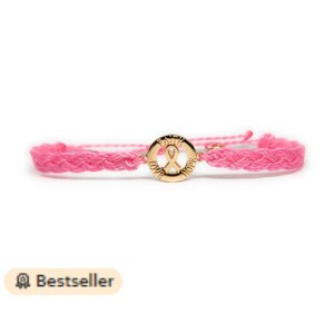 May include: Pink braided bracelet with a gold charm featuring a pink ribbon and the words "Faith, Love, Hope".