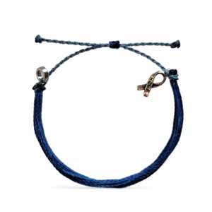 May include: Blue and gray braided string bracelet with a silver ribbon charm that says "HOPE".