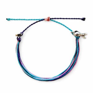 May include: A multi-colored friendship bracelet with a silver charm that says "HOPE" and a ribbon attached to it. The bracelet is made of blue, purple, pink, and turquoise threads.