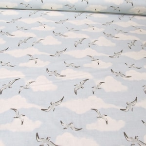 May include: A light blue fabric with a white cloud and seagull pattern. The fabric is perfect for crafting projects, quilting, and home decor.