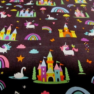 Op de afbeelding: Een donkerbruine stof met een herhalend patroon van kleurrijke eenhoorns, regenbogen, kastelen en sterren.