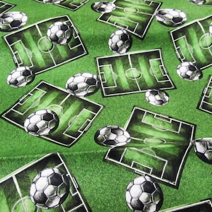 Puede incluir: Tela verde con un patrón repetido de balones de fútbol y campos de fútbol. Los balones son blancos y negros, y los campos son verdes con líneas blancas. El fondo es de color verde liso.