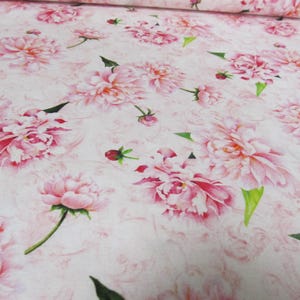 May include: Pink floral fabric with a white background and a watercolor-like design. The fabric features a repeating pattern of pink peonies with green leaves.