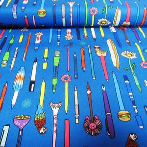 May include: Blue fabric with a repeating pattern of colorful pens and pencils. The pens feature various designs, including a hamburger, a cat, and a flower. The fabric is suitable for crafting and sewing projects.